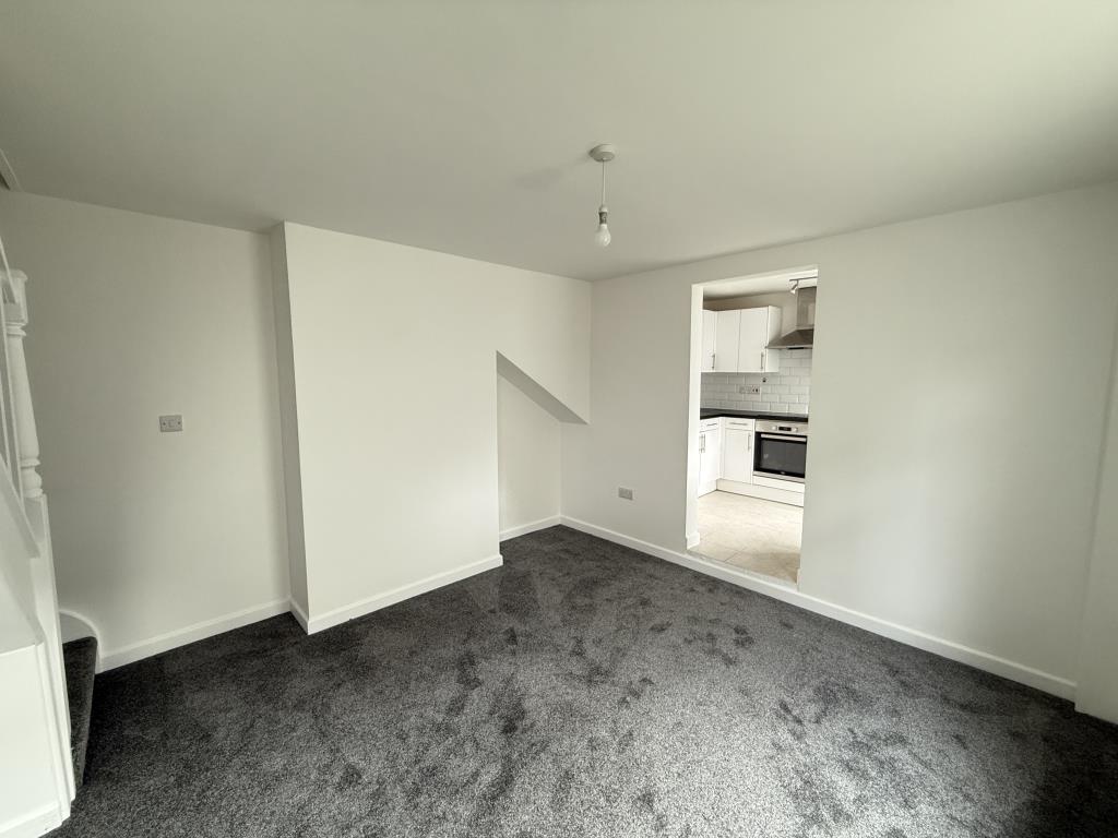 Lot: 157 - SEMI-DETACHED TWO-BEDROOM HOUSE FOR INVESTMENT OR OCCUPATION - Dining room with kitchen and stairs in view